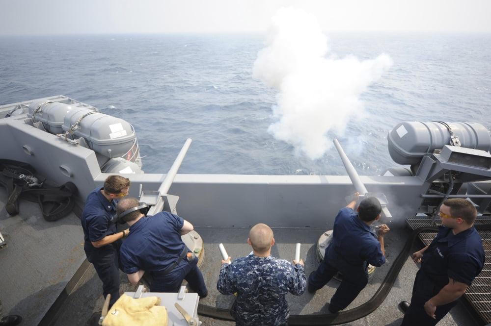 Sailors perform a 21-gun salute aboard USS Dwight D Eisenhower Canvas Art - Stocktrek Images (35 x 23)