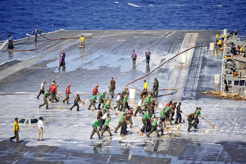 Sailors perform a flight deck wash down aboard the aircraft carrier USS George Washington Canvas Art - Stocktrek Images (35 x 24)
