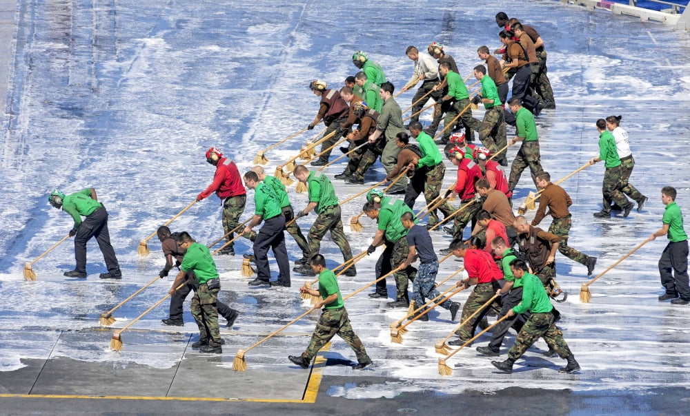Sailors perform a flight deck wash down aboard the aircraft carrier USS George Washington Canvas Art - Stocktrek Images (36 x 22)