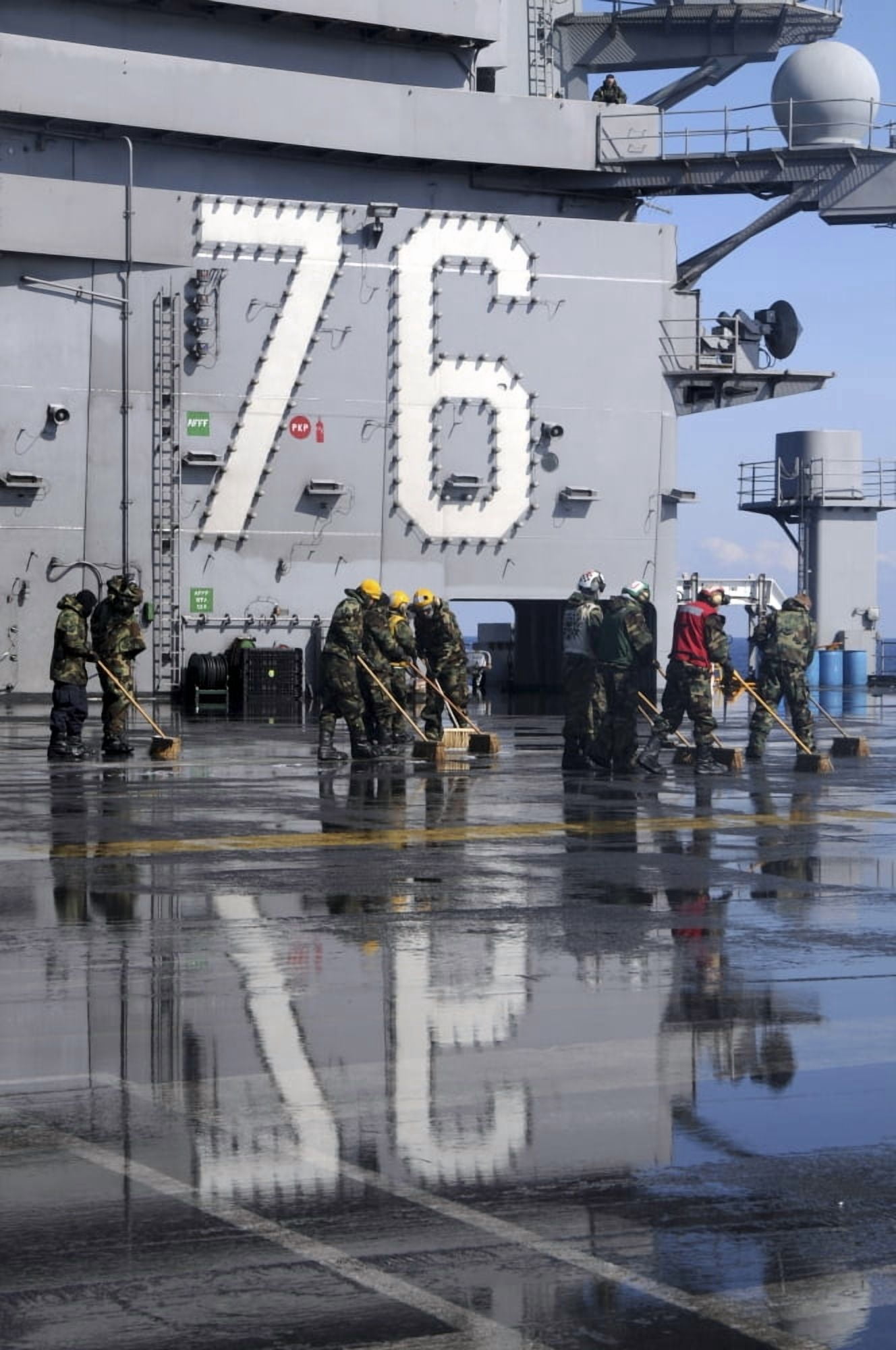 Sailors scrub the flight deck aboard the aircraft carrier USS Ronald Reagan Canvas Art - Stocktrek Images (23 x 34)