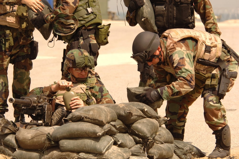 Sailors stack sand bags around a shipmate manning a 50-caliber machine gun Canvas Art - Stocktrek Images (34 x 23)