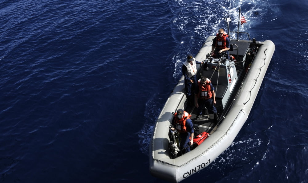Sailors stand watch on a rigid-hull inflatable boat prior to a swim call Canvas Art - Stocktrek Images (37 x 22)