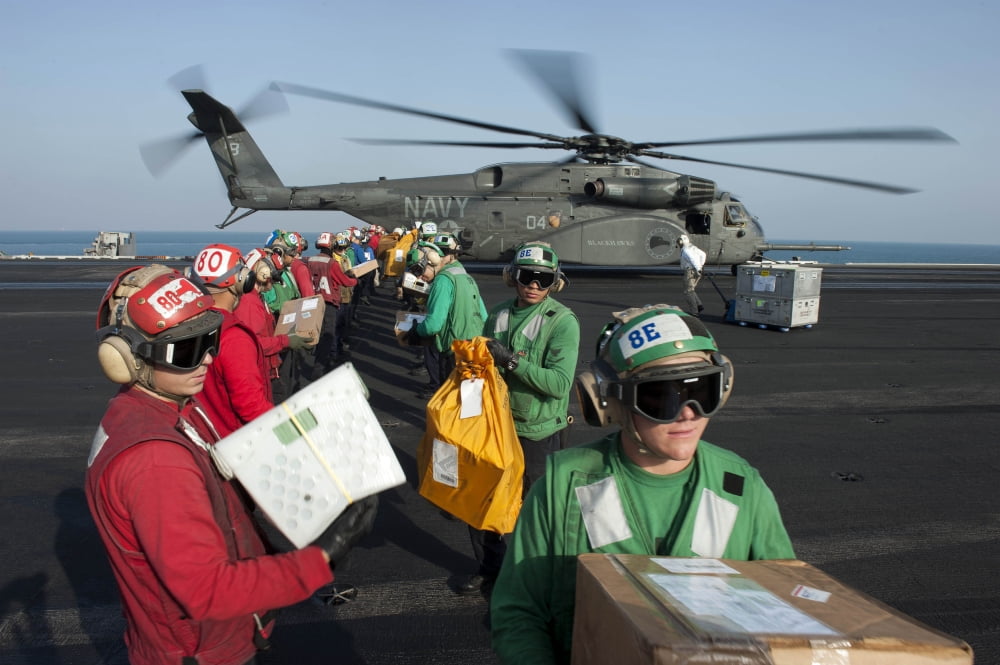 Sailors unload mail from an MH-53E Sea Dragon Canvas Art - Stocktrek Images (34 x 23)