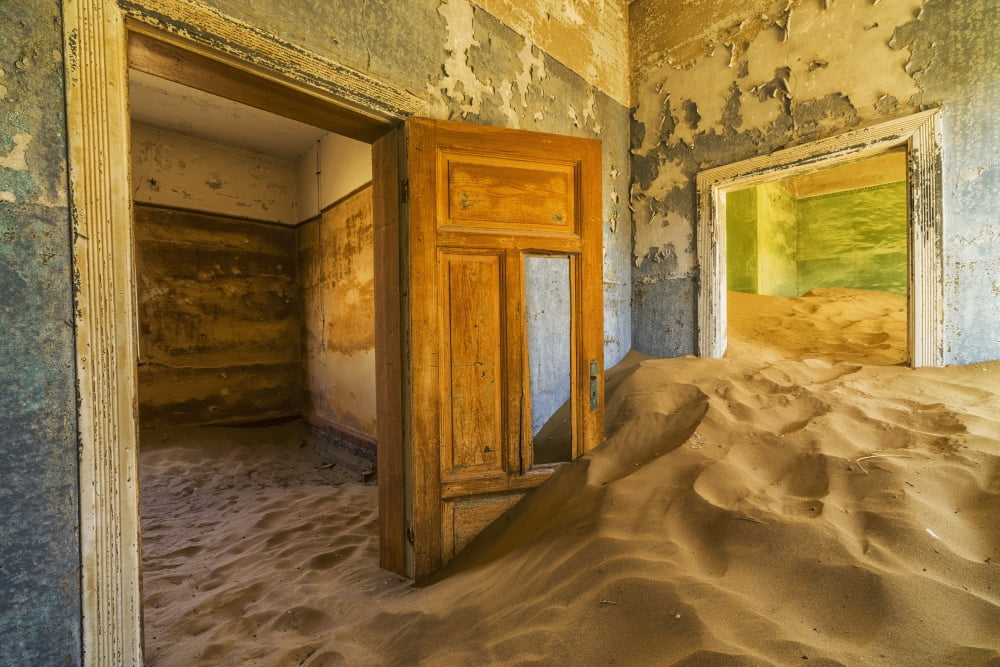 Sand in the rooms of a colourful and abandoned house Kolmanskop Namibia Canvas Art - Robert Postma Design Pics (19 x 12)