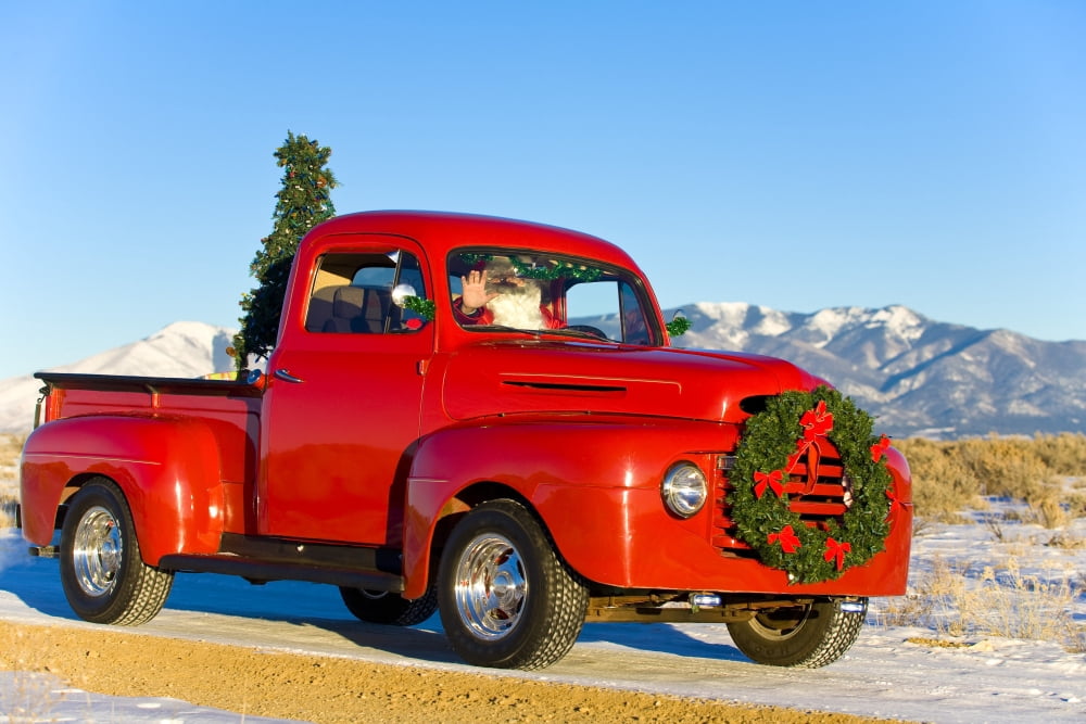 Santa Driving A Vintage Red Ford Pick-Up Truck Down A Snowcovered Rural Road In The Rio Grande Valley Of New Mexico Canvas Art - Michael DeYoung Design Pics (34 x 22)