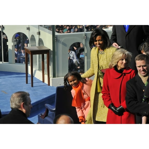 Sasha Obama Peeks Around Her Mother To Watch As Guests Arrive For The Inauguration Of Her Father At The U.S. Capitol In