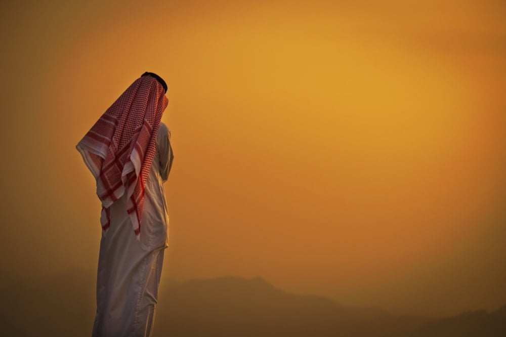 Saudi standing to watch the glowing orange sunset Taif Saudi Arabia Canvas Art - David Kirkland  Design Pics (19 x 12)