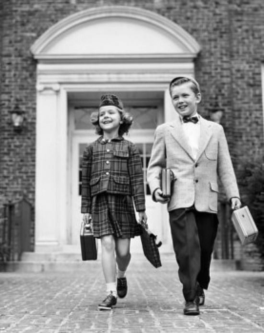 Schoolboy and a schoolgirl holding schoolbags and walking Canvas Art - (18 x 24)