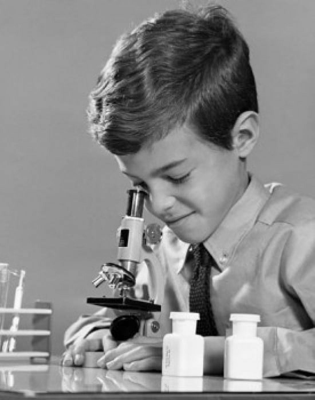 Schoolboy looking through a microscope Canvas Art - (24 x 36)