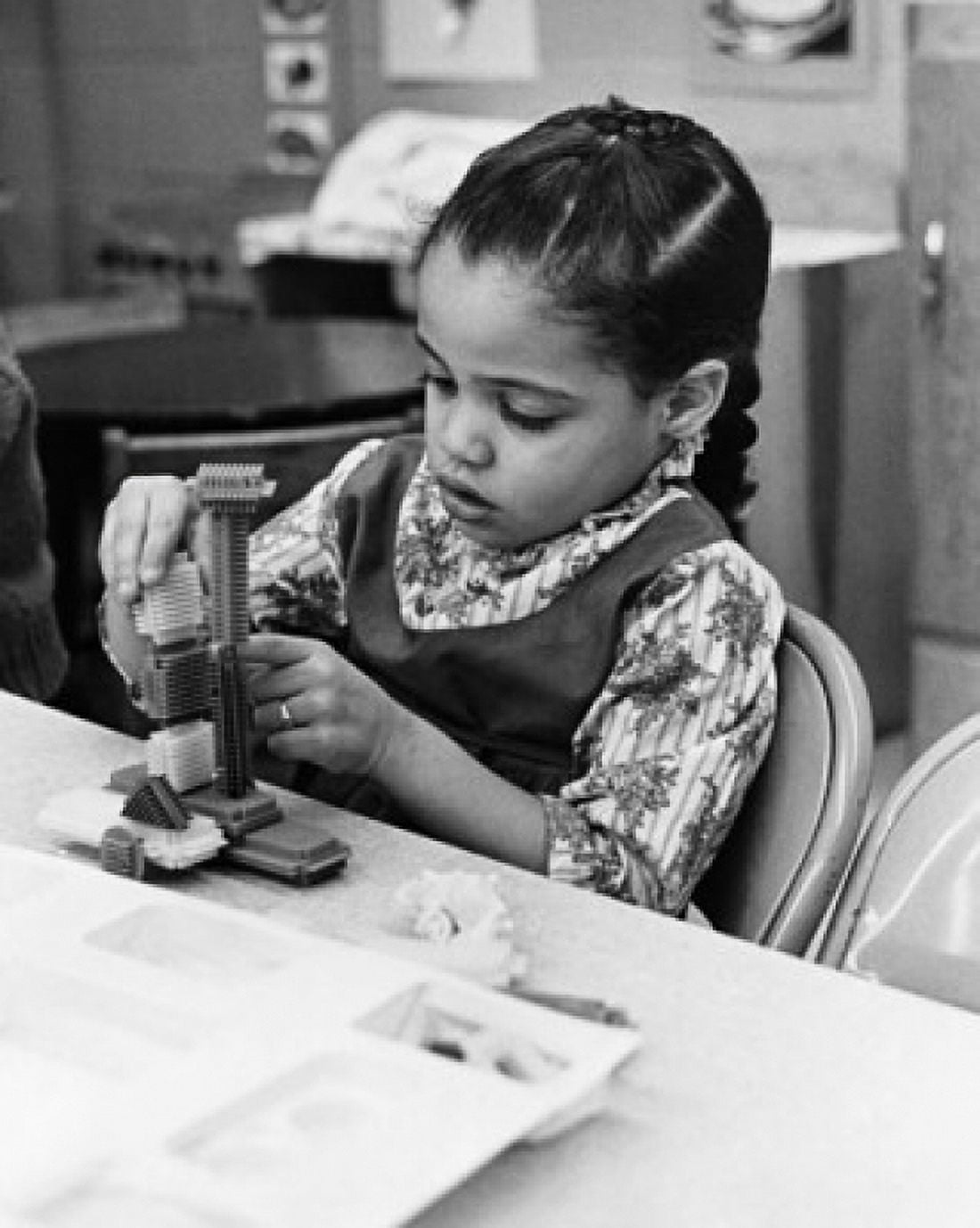 Schoolgirl playing with blocks in a classroom Canvas Art - (24 x 36)