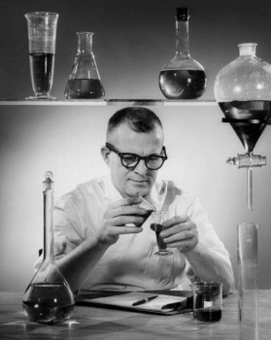 Scientist pouring chemicals in a laboratory Canvas Art - (18 x 24)