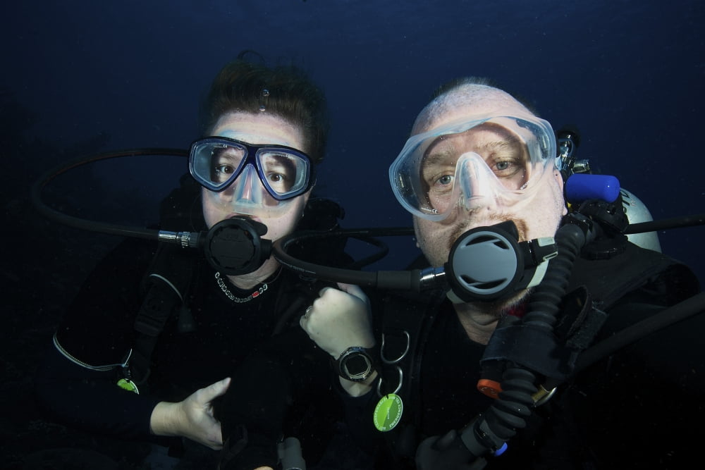 Scuba divers pose for the camera underwater Canvas Art - Terry MooreStocktrek Images (18 x 12)