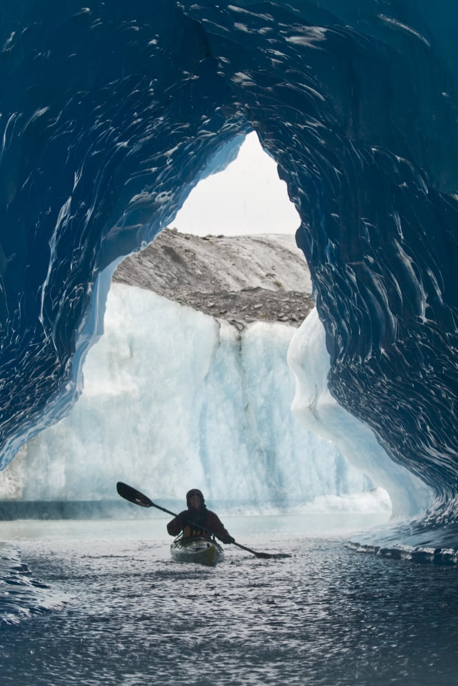 Sea Kayaker Paddles Through An Ice Cave Amongst Giant Icebergs Near Bear Glacier In Resurrection Bay Near Seward Alaska Canvas Art - Doug Demarest Design Pics (22 x 34)