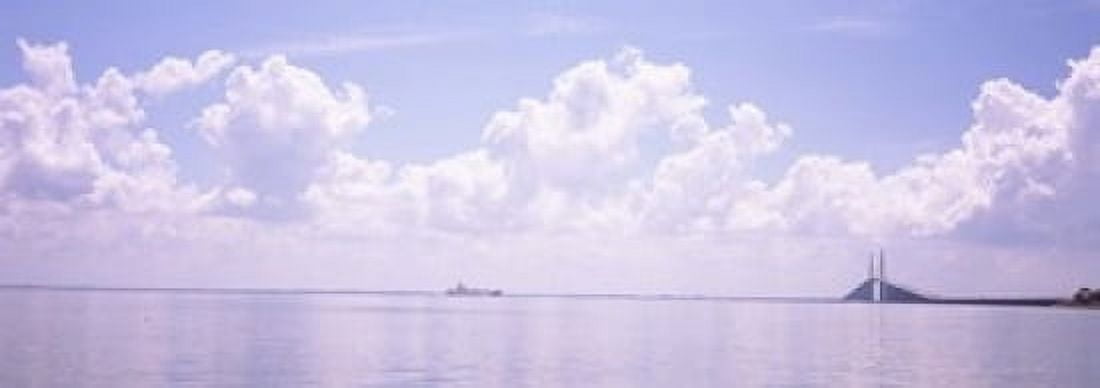 Sea with a container ship and a suspension bridge in distant Sunshine Skyway Bridge Tampa Bay Gulf of Mexico Florida USA Canvas Art - Panoramic Images (18 x 7)