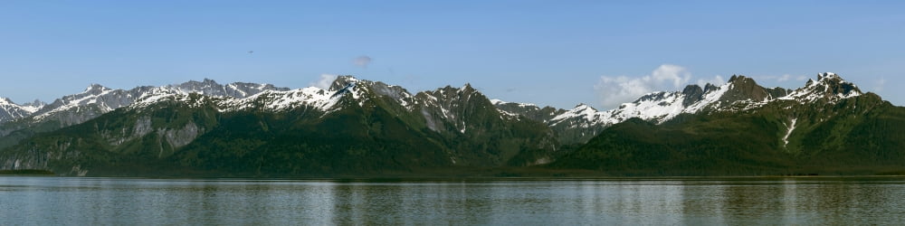 Sea with snowcapped mountain range in background Southeast Alaska Alaska USA Canvas Art - Panoramic Images (48 x 12)