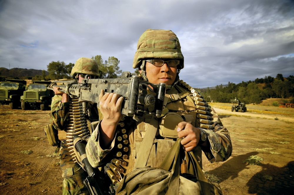 Seabees carrying a 50-caliber machine gun at Fort Hunter Liggett California Canvas Art - Stocktrek Images (35 x 23)