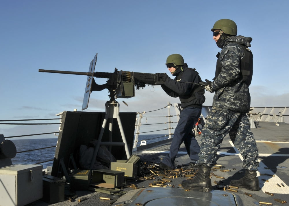 Seaman fires a 50 caliber machine gun aboard USS Thach Canvas Art - Stocktrek Images (34 x 24)