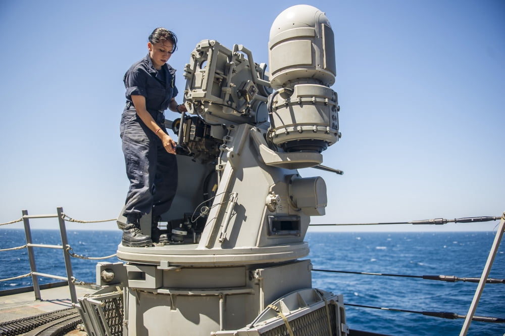 Seaman performs maintenance on a Mark 38 MOD 2 25mm machine gun Canvas Art - Stocktrek Images (34 x 23)