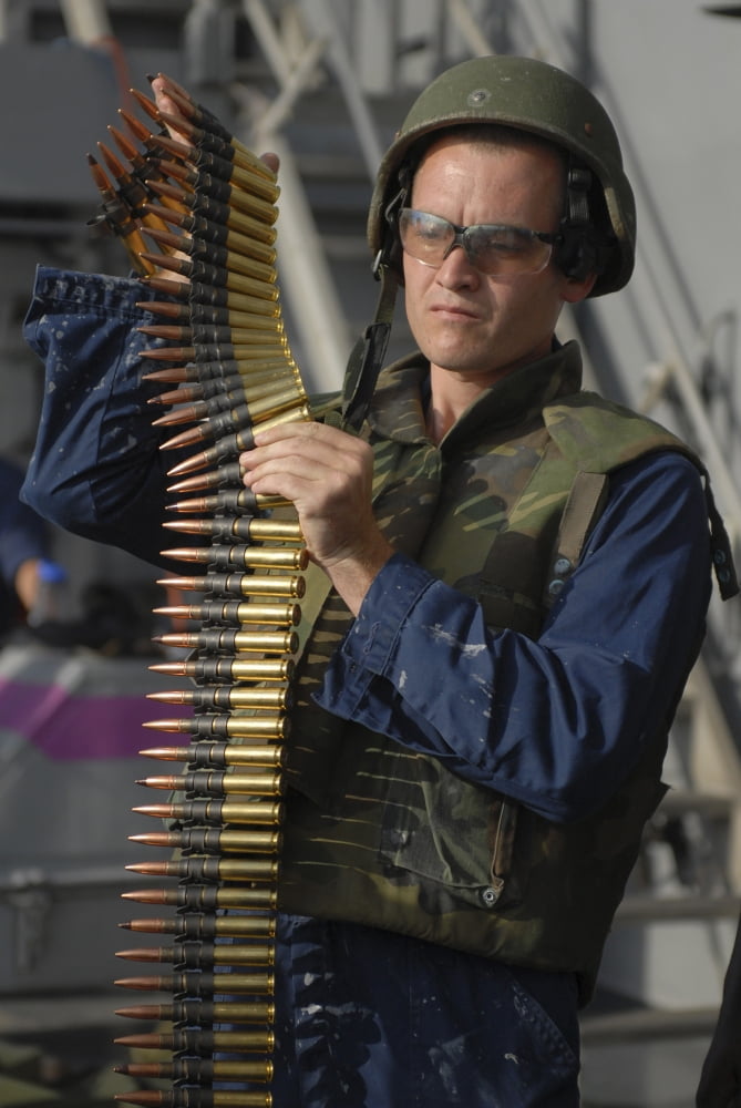 Seaman prepares to load ammunition into an M240 machine gun Canvas Art - Stocktrek Images (24 x 35)