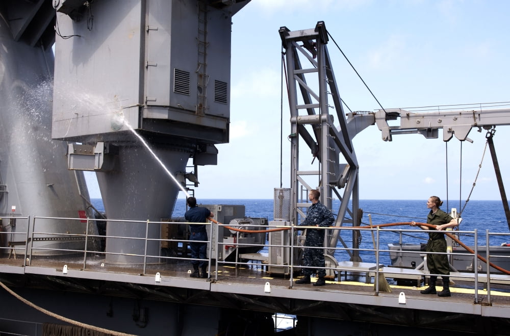 Seamen conduct a fresh water wash down on the 20-ton crane aboard USS Whidbey Island Canvas Art - Stocktrek Images (35 x 23)