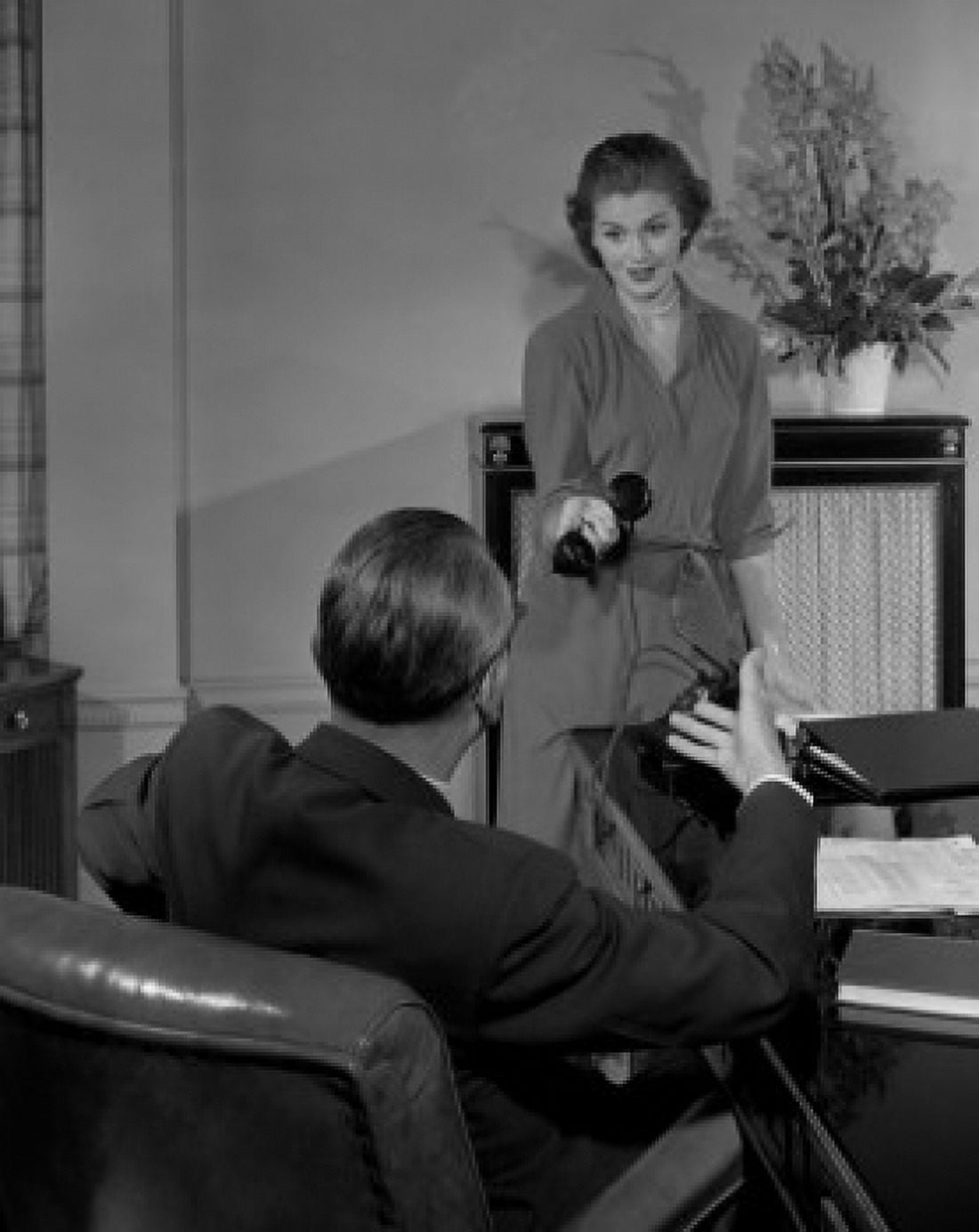 Secretary giving phone receiver to boss in office Canvas Art - (24 x 36)