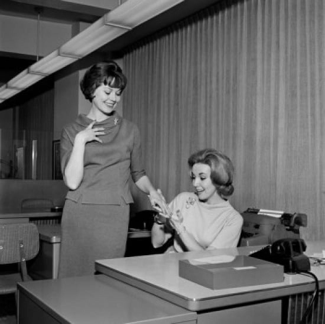 Secretary showing painted fingernails to colleague Canvas Art - (18 x 24)