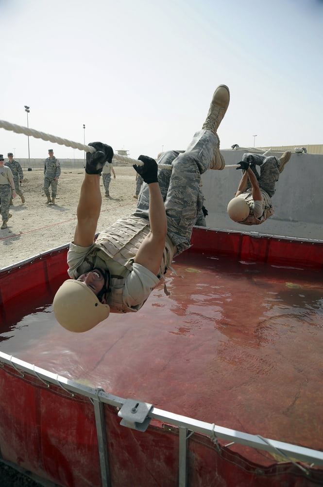 Senior Airman uses a 15 foot rope to cross a water obstacle Canvas Art - Stocktrek Images (23 x 34)