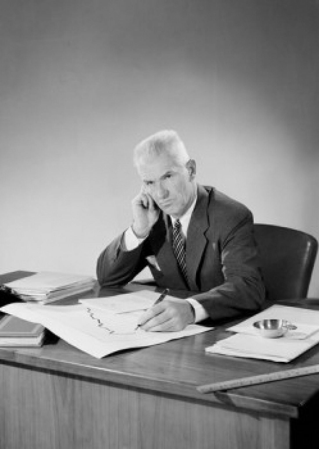 Senior businessman sitting behind desk Canvas Art - (24 x 36)