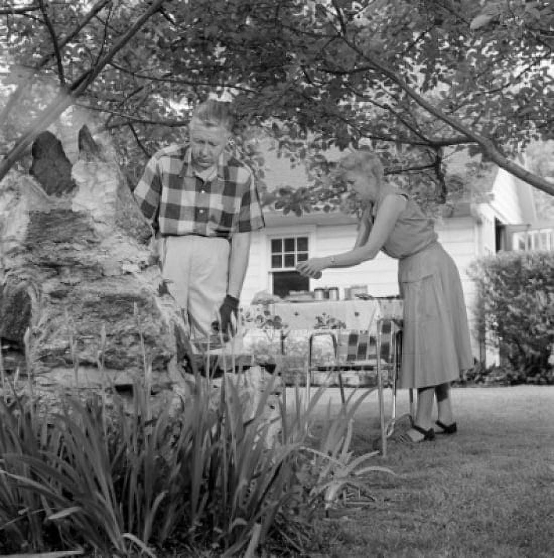 Senior couple having barbecue in backyard Canvas Art - (24 x 36)