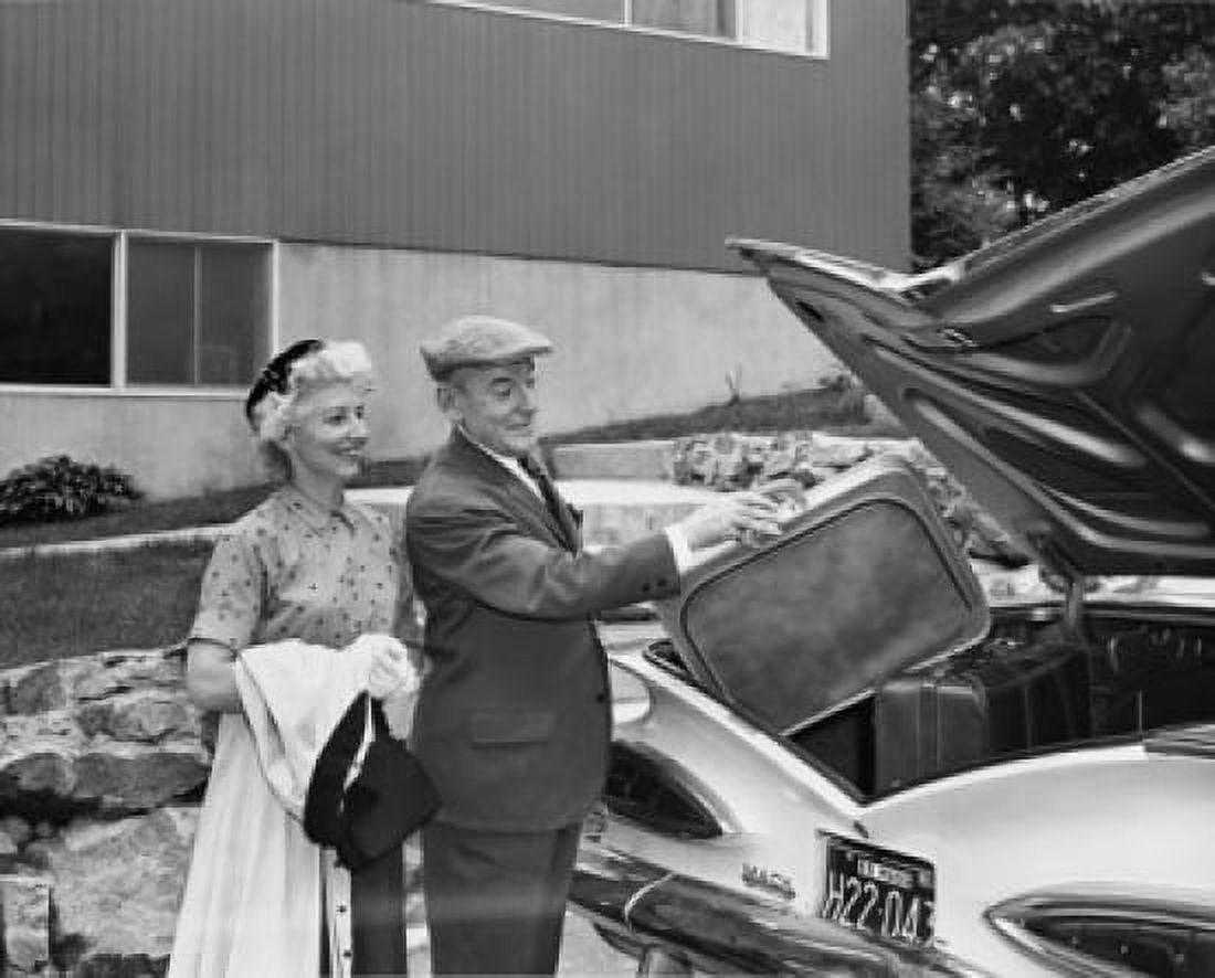 Senior couple loading luggage into a car Canvas Art - (18 x 24)