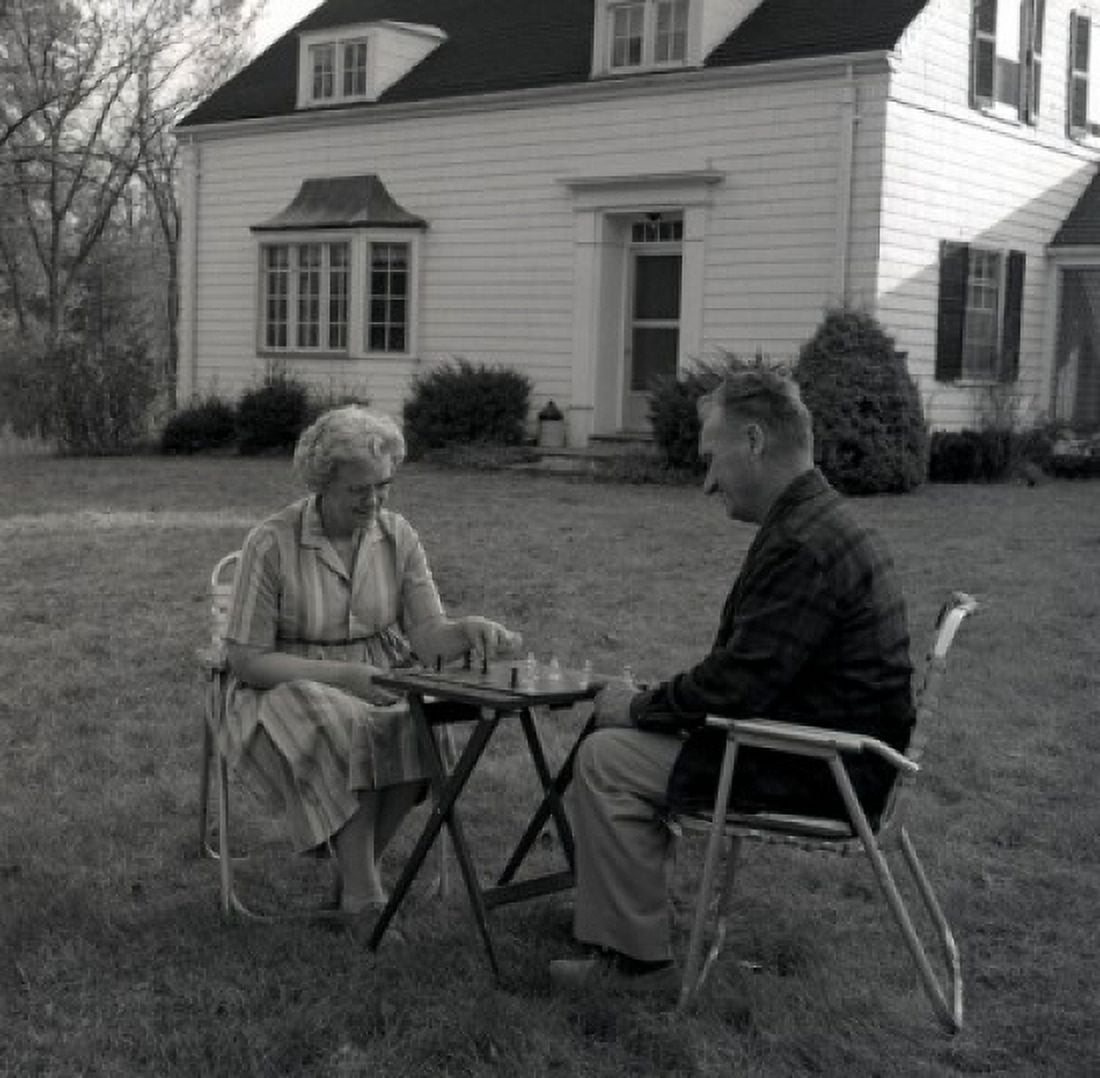 Senior couple playing chess outside house Canvas Art - (18 x 24)