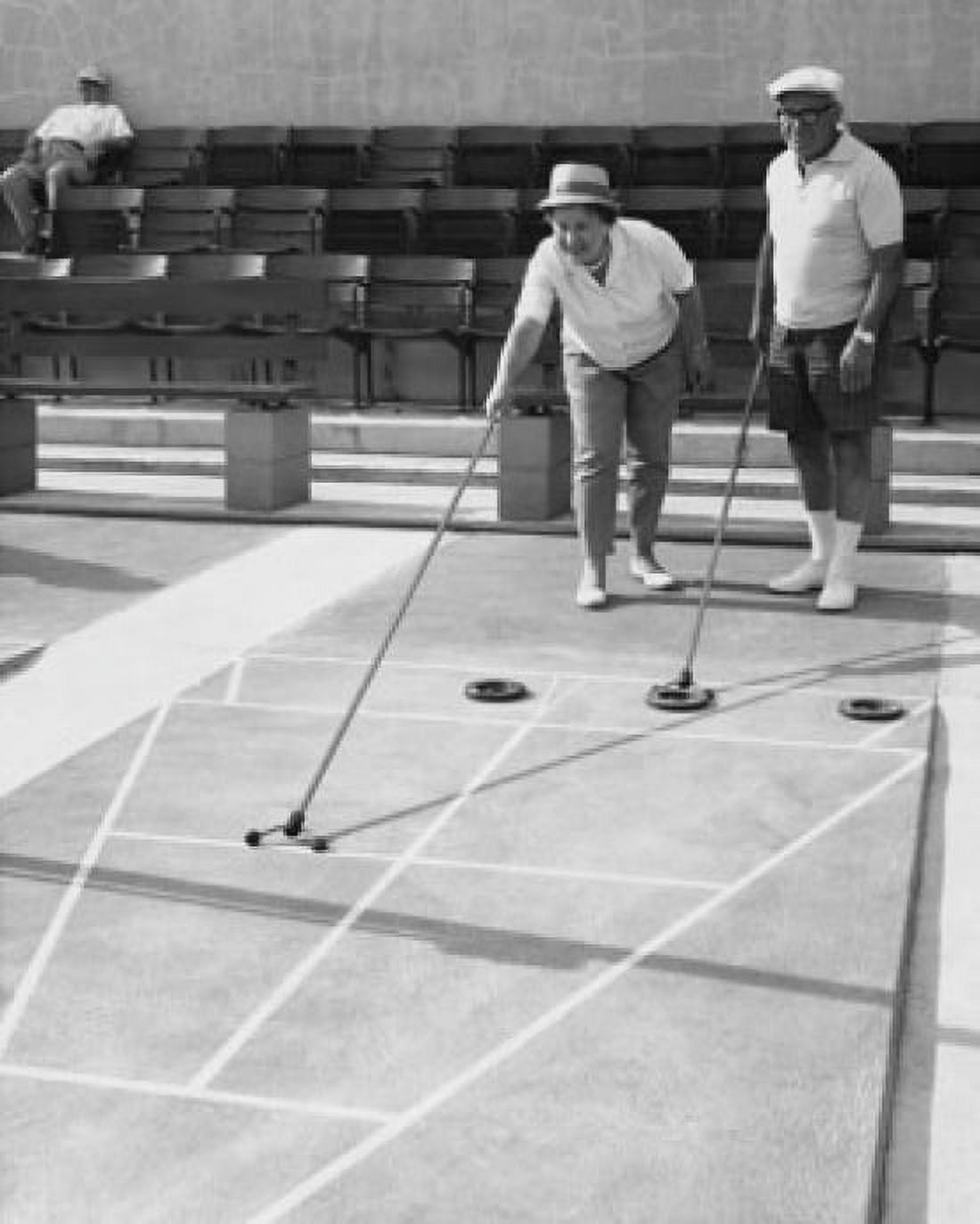 Senior couple playing shuffleboard Canvas Art - (24 x 36)