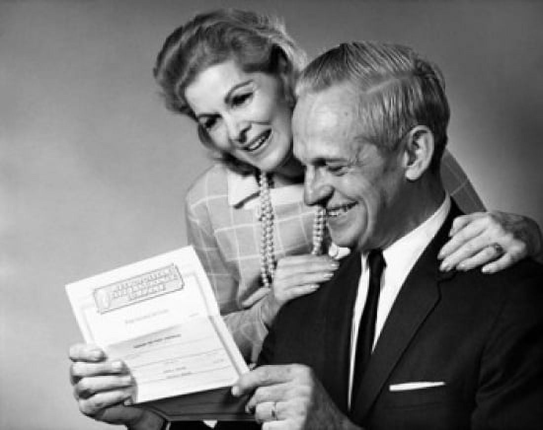 Senior couple reading a document and smiling Canvas Art - (18 x 24)