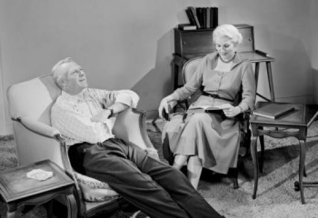 Senior couple relaxing in living room Canvas Art - (18 x 24)