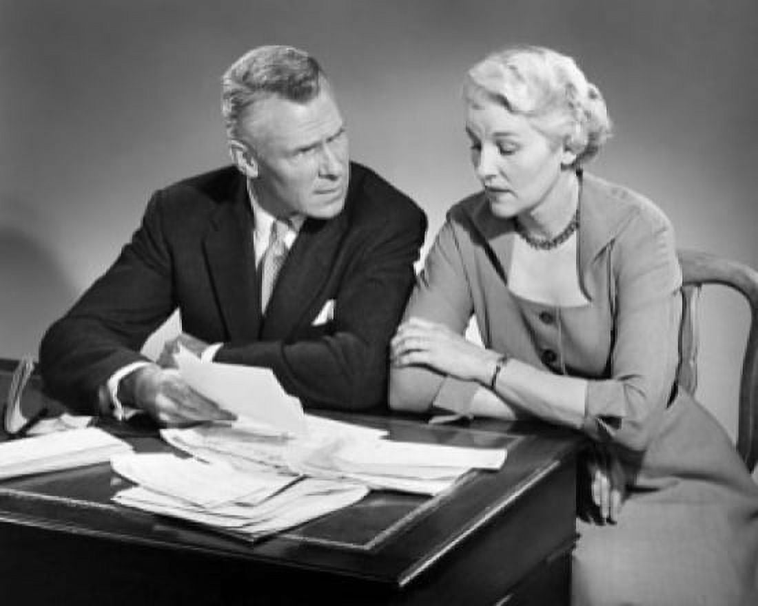 Senior couple sitting at a table and sorting out bills Canvas Art - (24 x 36)