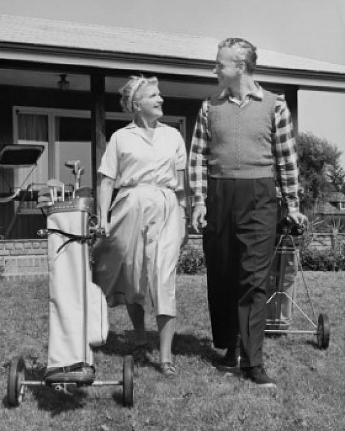 Senior couple walking with golf clubs on golf course Canvas Art - (18 x 24)