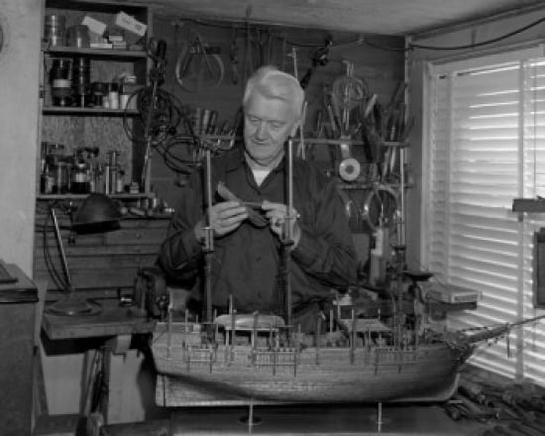 Senior man building model of ship Canvas Art - (24 x 36)