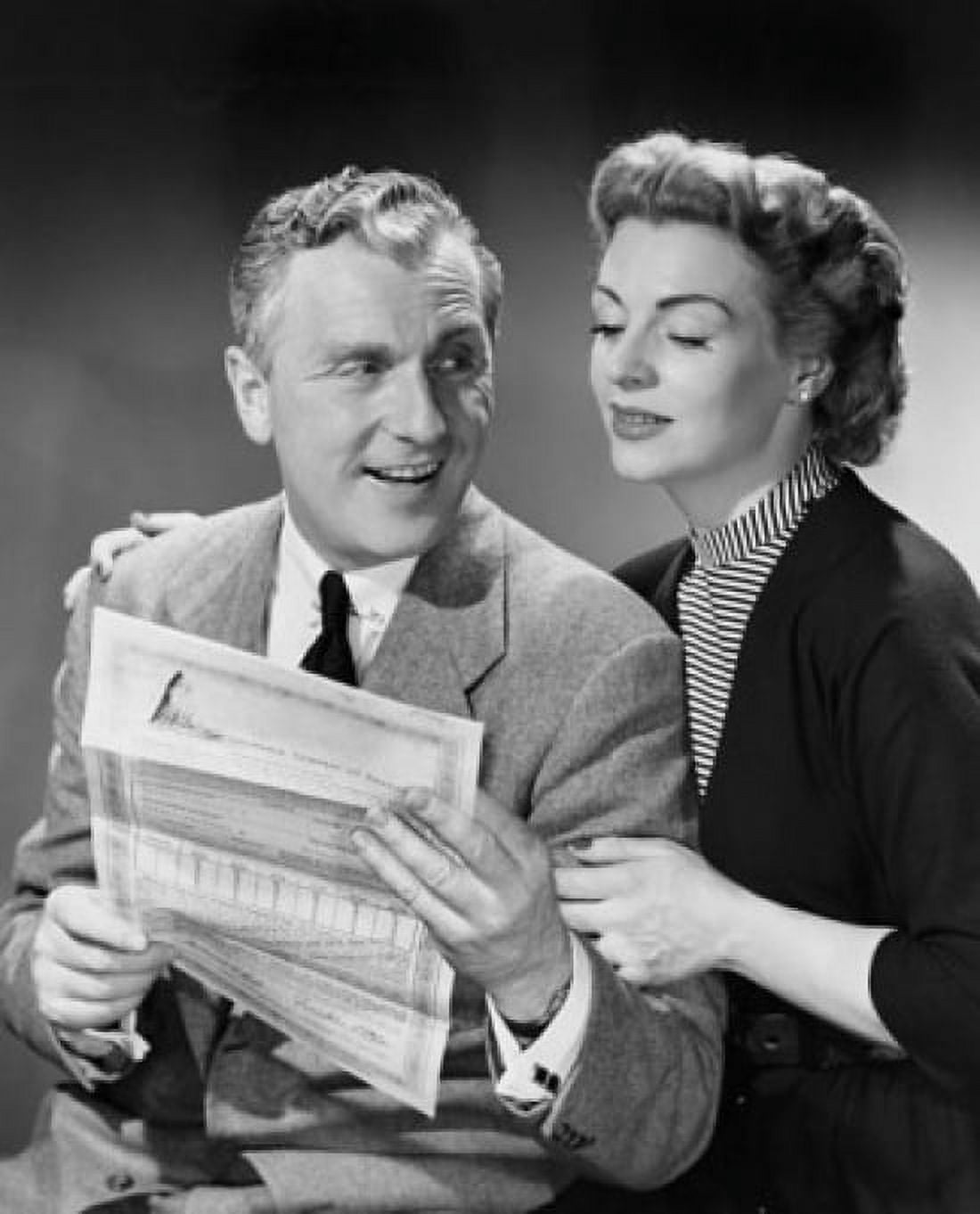 Senior man holding a bill with a senior woman sitting beside him Canvas Art - (18 x 24)
