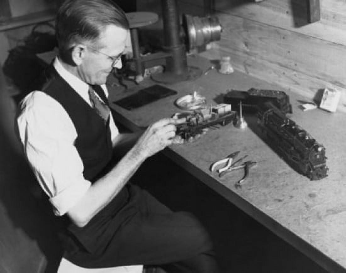 Senior man making a miniature train Canvas Art - (24 x 36)