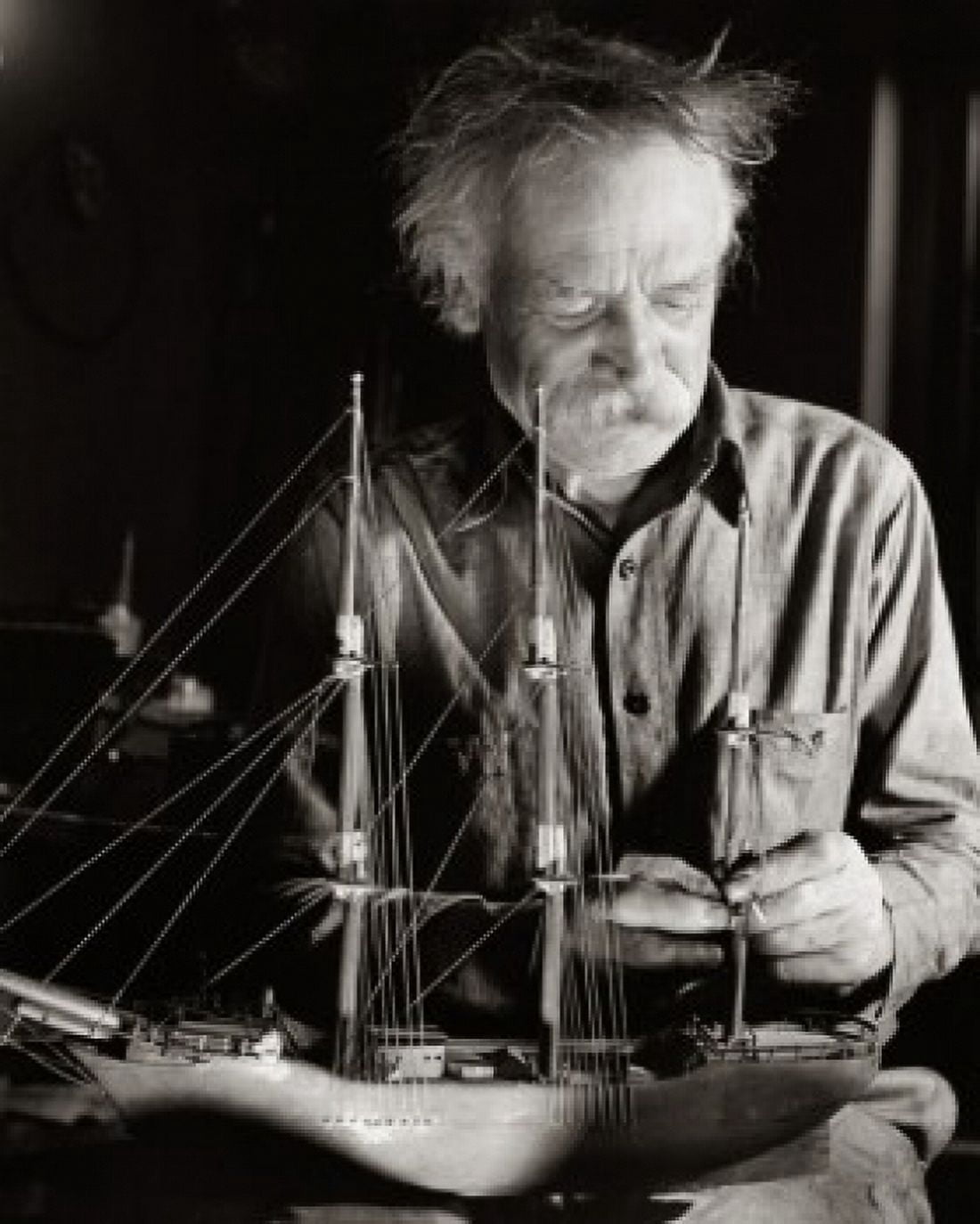 Senior man making a model of a sailing ship Canvas Art - (24 x 36)