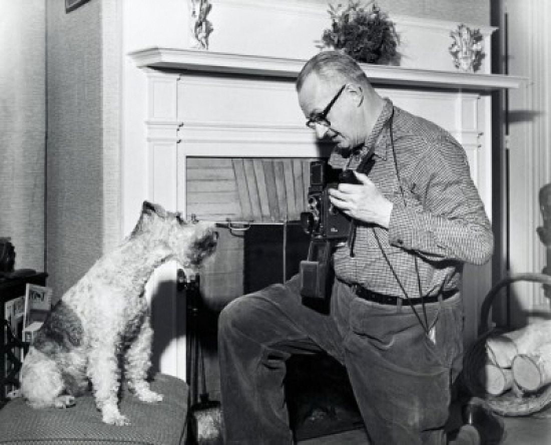 Senior man photographing dog in living room Canvas Art - (18 x 24)