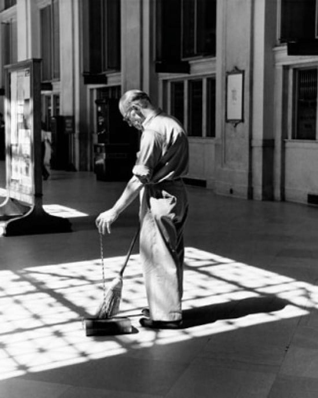Senior man sweeping a floor Canvas Art - (24 x 36)