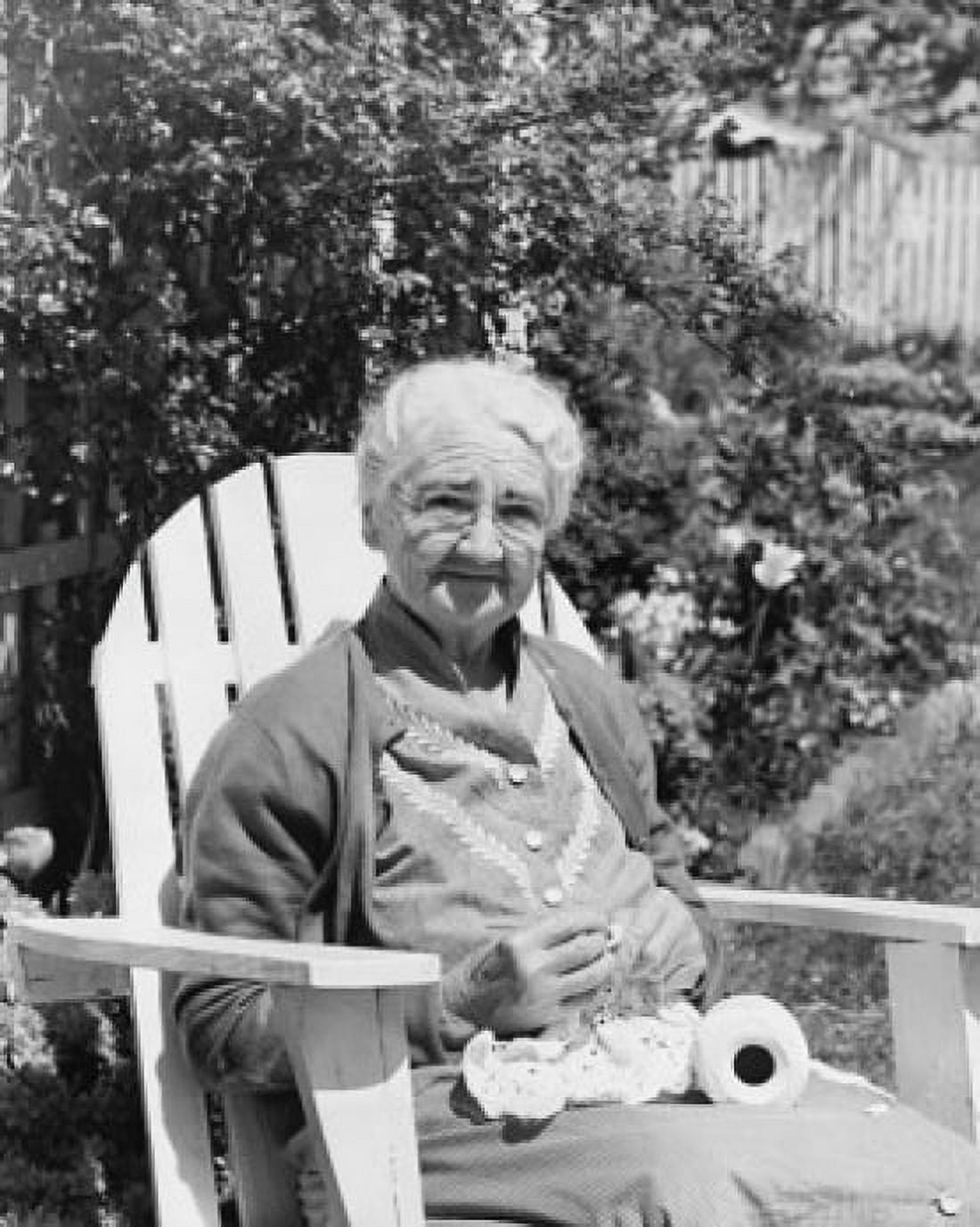 Senior woman sitting in an adirondack chair and crocheting Canvas Art - (18 x 24)