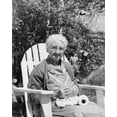 thumbnail image 1 of Senior woman sitting in an adirondack chair and crocheting Poster Print (18 x 24), 1 of 1