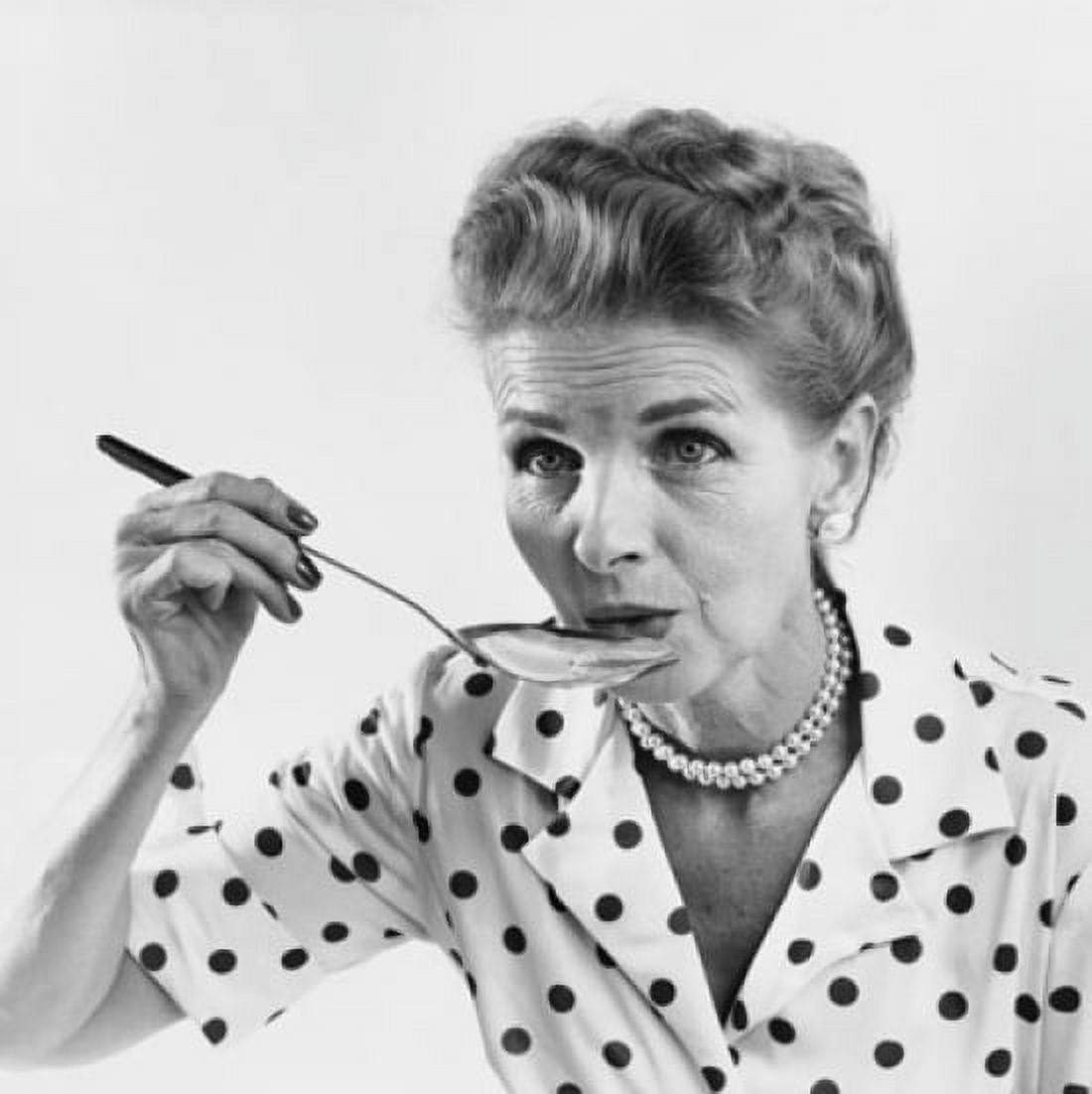 Senior woman tasting food with a spoon Canvas Art - (18 x 24)