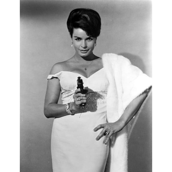 Senta Berger standing in White Dress with Pistol Photo Print (24 x 30)