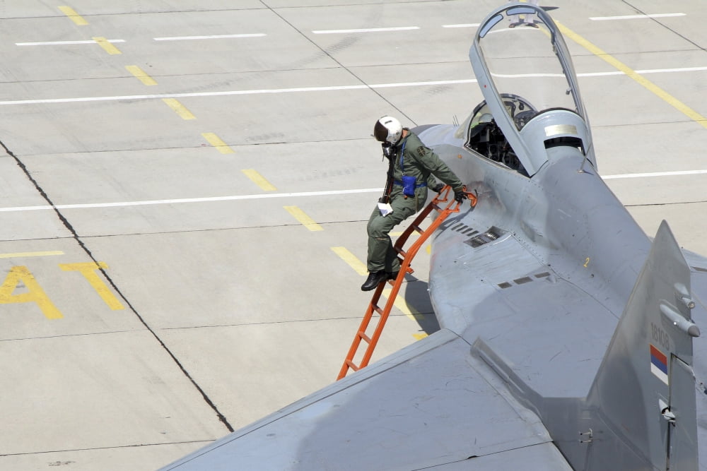 Serbian Air Force pilot climbs down from the cockpit of a MiG-29 Canvas Art - Anton BalakchievStocktrek Images (18 x 12)