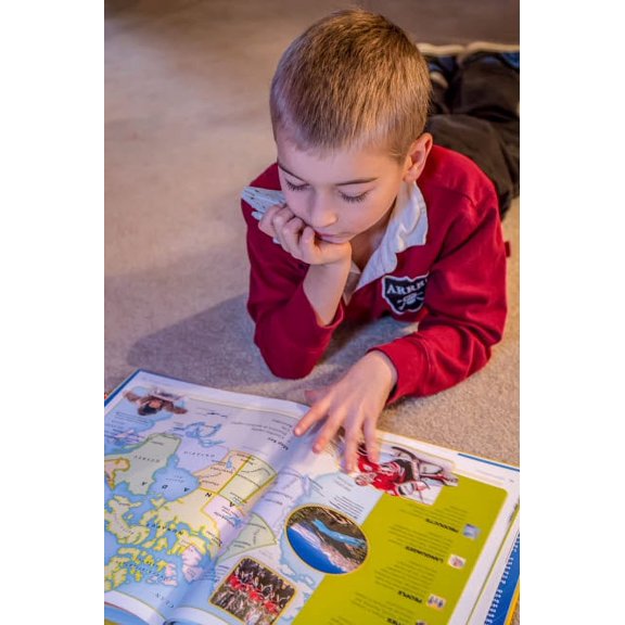 Seven year old boy reading his world atlas book (MR) Poster Print by Janet Horton (18 x 24) # US48JHO1372