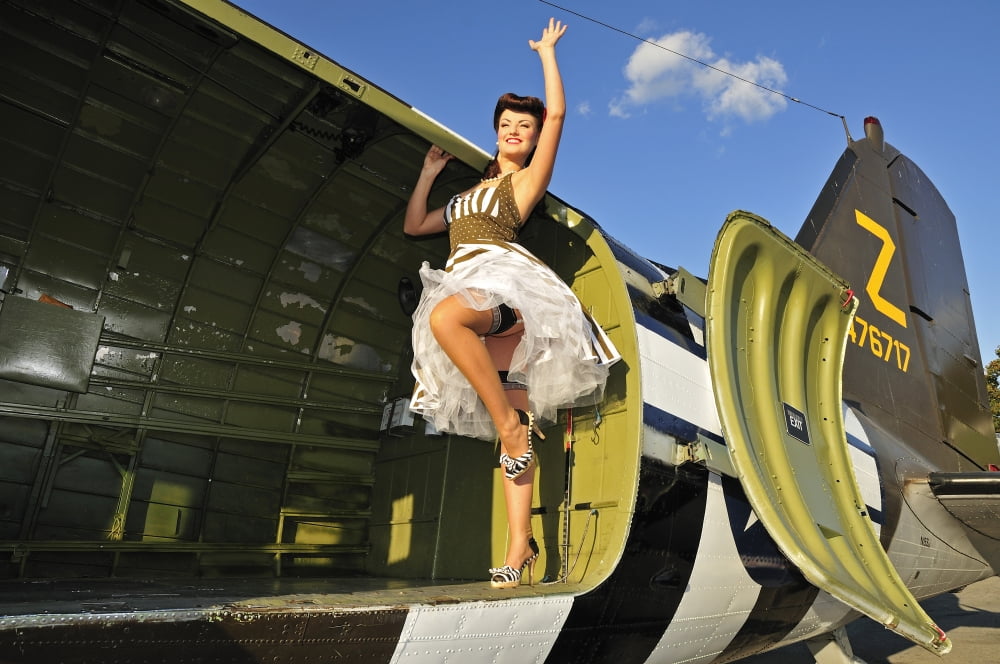 Sexy 1940s style pin-up girl standing inside of a C-47 Skytrain aircraft Canvas Art - Christian KiefferStocktrek Images (18 x 12)