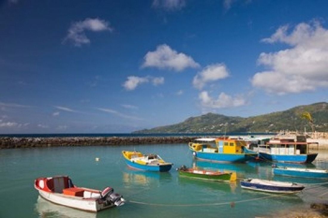 Seychelles Mahe Island Bel Ombre town pier Canvas Art - Walter Bibikow DanitaDelimont (19 x 12)